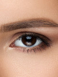 Brown eye with clear contact lens.